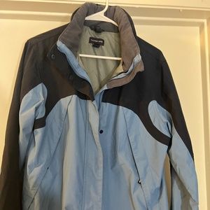 Lands End  Lightweight Jacket with  Multiple  Pockets and roll up hood.